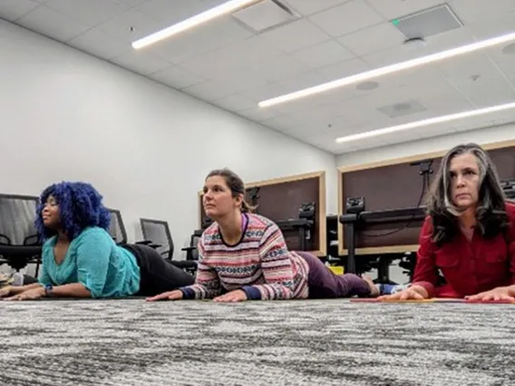 Employees practicing yoga