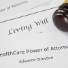 Legal documents including Living Will, Power of Attorney, and Healthcare Power of Attorney with gavel and pen, representing advance healthcare planning and legal preparation.